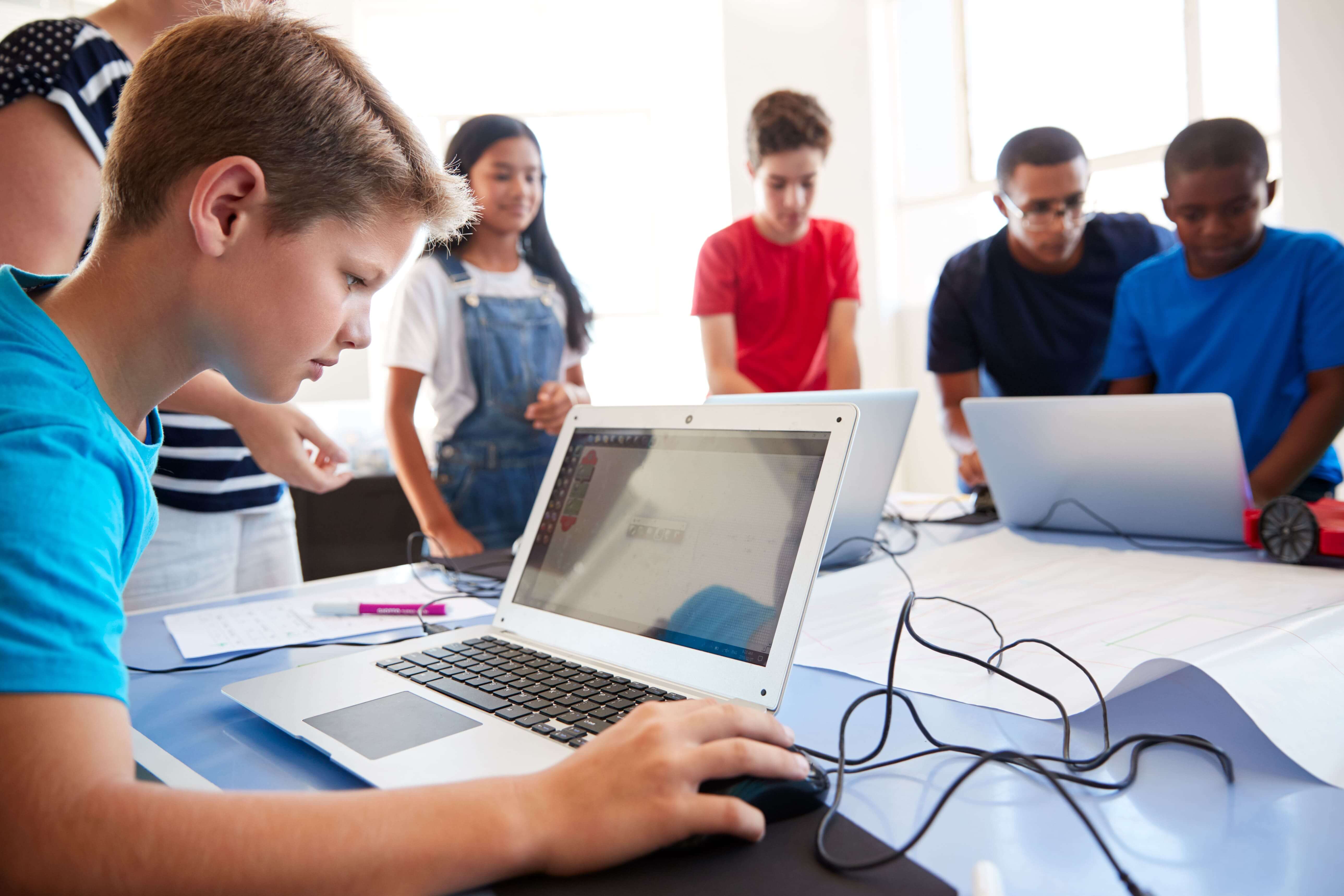 A group of students and instructors in a computer lab